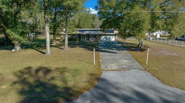 view of front facade featuring a garage and a front lawn