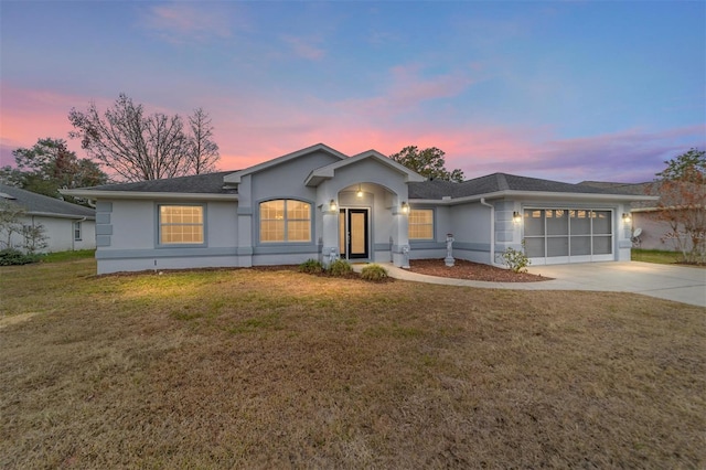 view of front of property featuring a garage and a yard