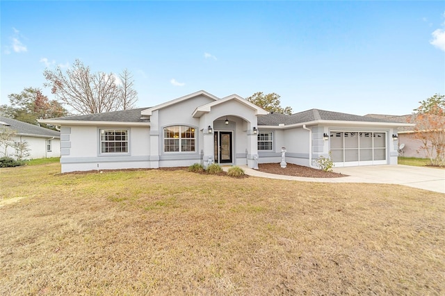 ranch-style house with a garage and a front lawn