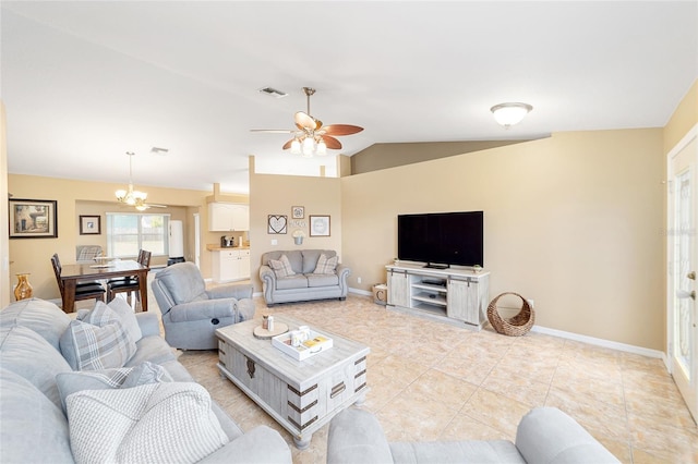 tiled living room with ceiling fan with notable chandelier and lofted ceiling