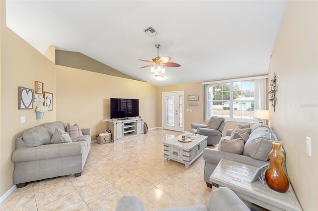 tiled living room with ceiling fan, vaulted ceiling, and french doors