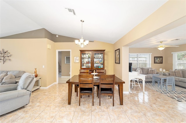 dining area featuring lofted ceiling and ceiling fan with notable chandelier