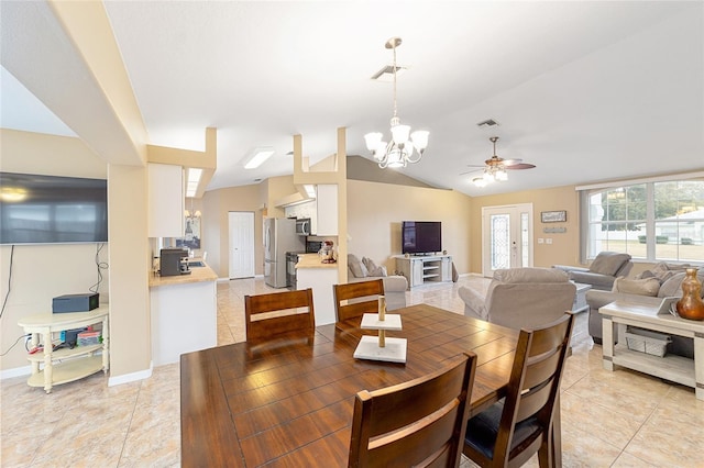 tiled dining room featuring lofted ceiling and ceiling fan with notable chandelier