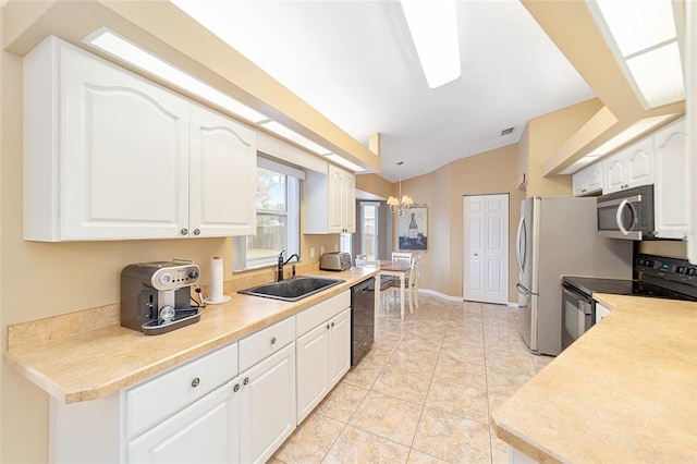 kitchen with black appliances, sink, white cabinetry, and pendant lighting