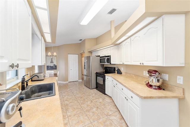 kitchen featuring white cabinets, decorative light fixtures, stainless steel appliances, an inviting chandelier, and sink