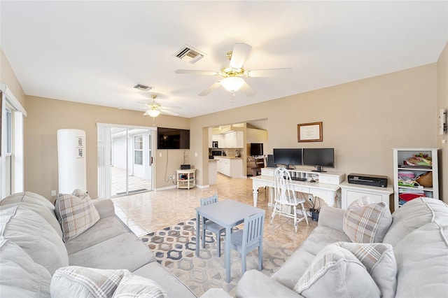 living room featuring ceiling fan and light tile patterned flooring