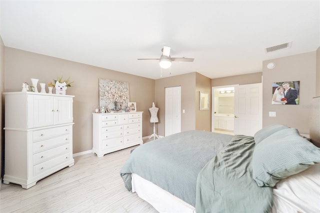 bedroom with ceiling fan, ensuite bath, and a closet