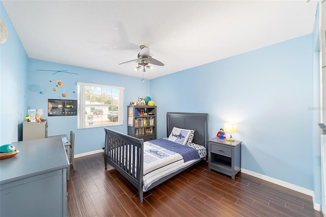 bedroom with ceiling fan and dark hardwood / wood-style floors