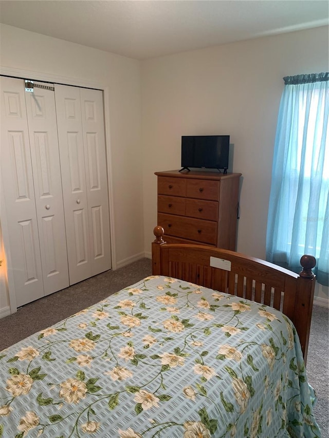 bedroom featuring dark carpet and a closet