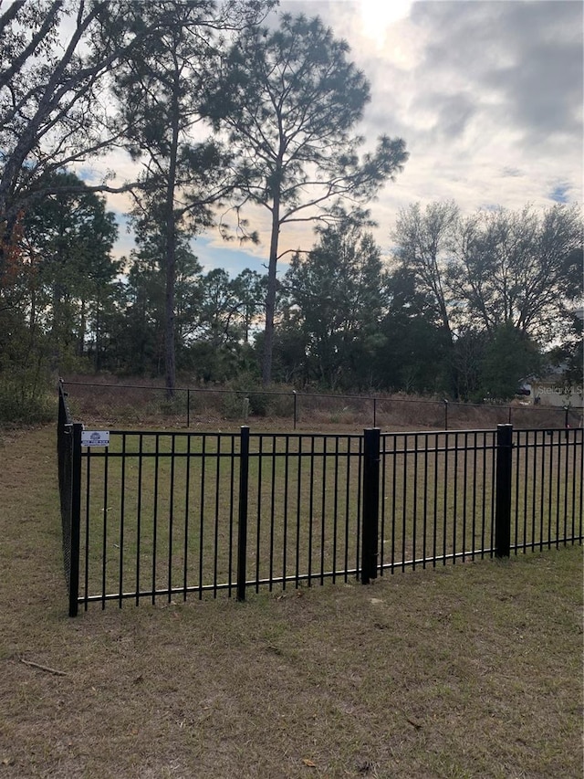 view of gate with a yard