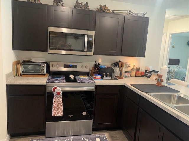 kitchen with stainless steel appliances and light wood-type flooring