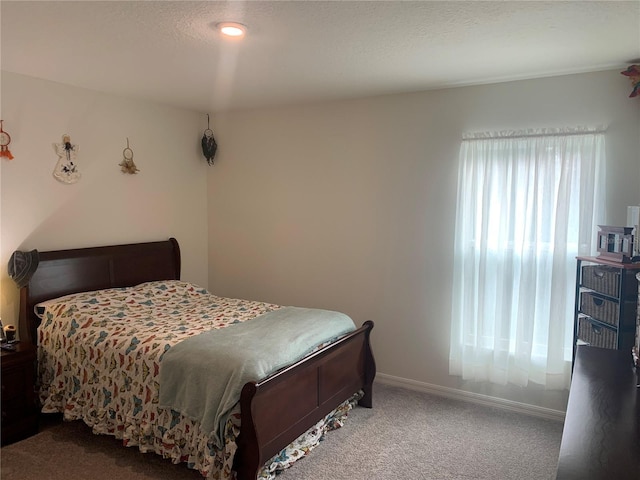 carpeted bedroom featuring a textured ceiling