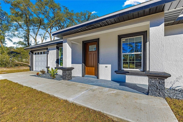 doorway to property with a garage