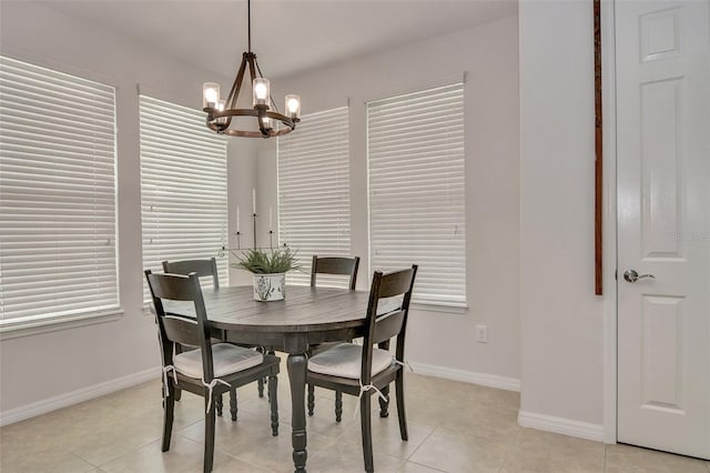 dining room featuring a chandelier and light tile patterned flooring