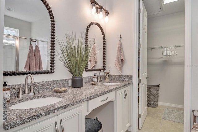 bathroom featuring an enclosed shower, vanity, and tile patterned floors