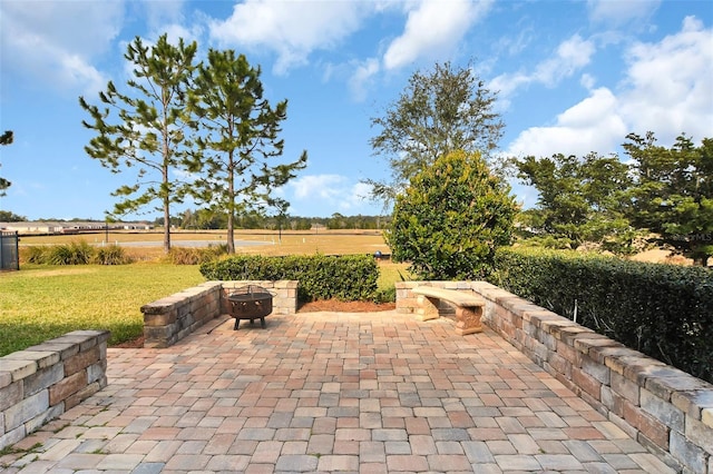 view of patio / terrace featuring an outdoor fire pit