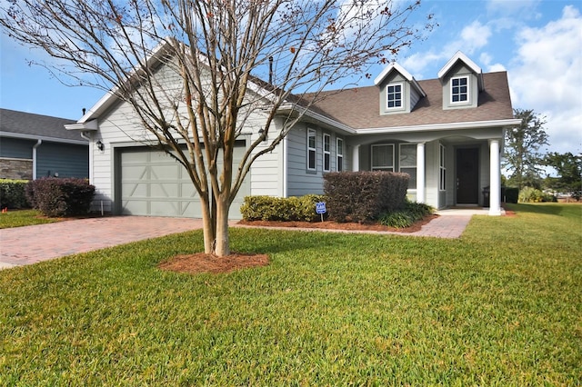 view of front of property with a garage and a front lawn