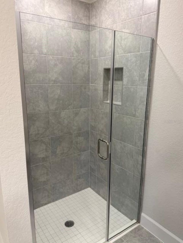 2158 NW 23rd Loop, Ocala, FL 34475 - bathroom with baseboards and a stall shower