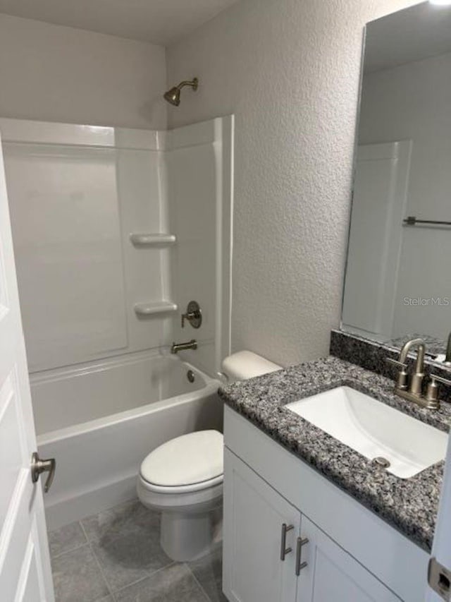2158 NW 23rd Loop, Ocala, FL 34475 - full bathroom with vanity, a textured wall, shower / bathtub combination, toilet, and tile patterned floors
