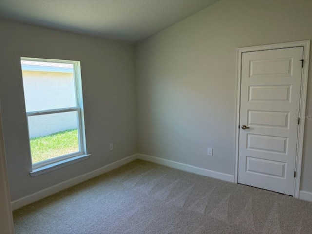 2158 NW 23rd Loop, Ocala, FL 34475 - empty room featuring carpet floors and baseboards