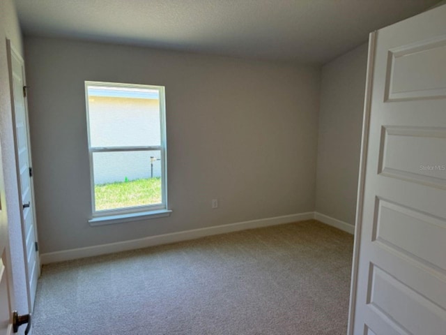 2158 NW 23rd Loop, Ocala, FL 34475 - spare room featuring baseboards and carpet