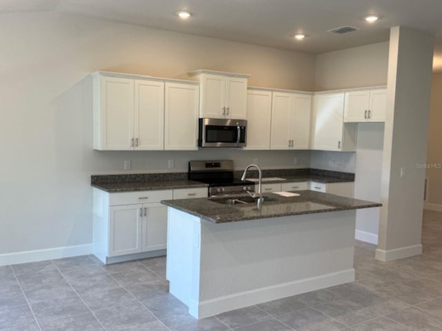 2158 NW 23rd Loop, Ocala, FL 34475 - kitchen featuring visible vents, a sink, baseboards, dark stone countertops, and stainless steel appliances