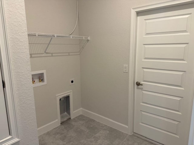 2158 NW 23rd Loop, Ocala, FL 34475 - laundry room featuring laundry area, washer hookup, baseboards, dark tile patterned flooring, and hookup for an electric dryer