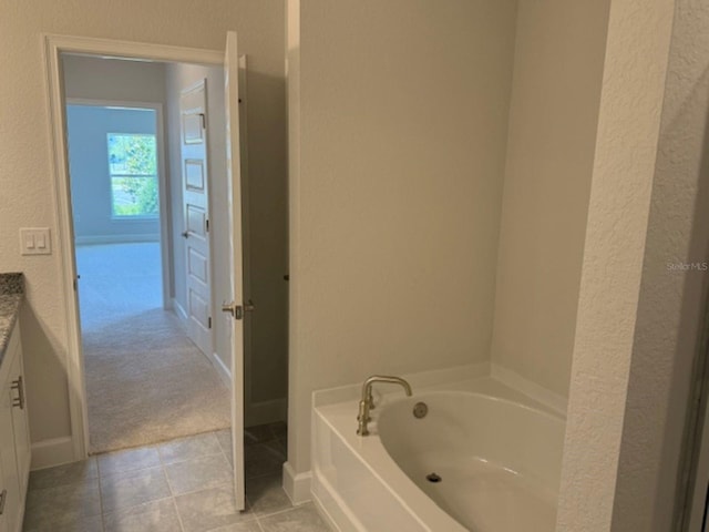 2158 NW 23rd Loop, Ocala, FL 34475 - full bath with a textured wall, tile patterned flooring, vanity, baseboards, and a bath