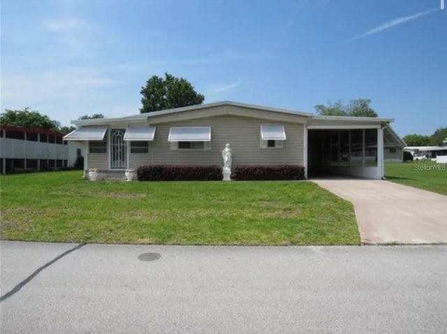 single story home featuring a front yard and a carport