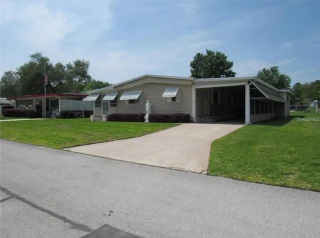 ranch-style home featuring a front yard and a carport