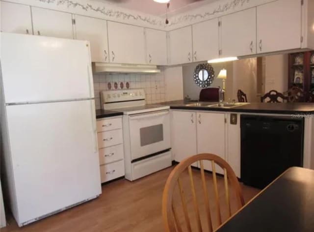 kitchen featuring decorative backsplash, white appliances, white cabinets, and light wood-type flooring