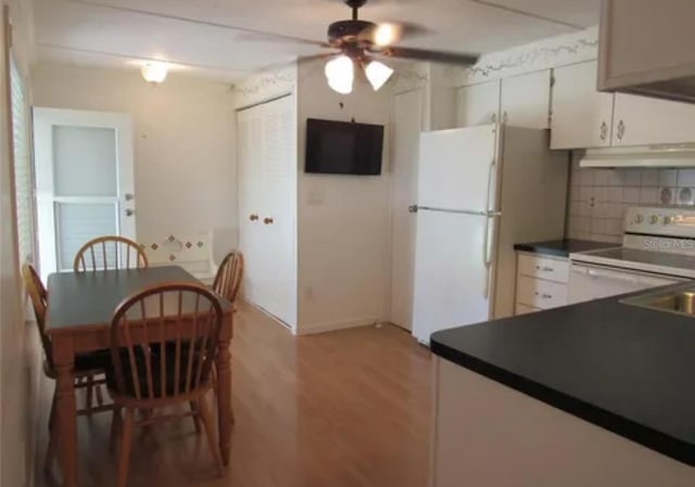 kitchen featuring ceiling fan, decorative backsplash, white appliances, light wood-type flooring, and white cabinets