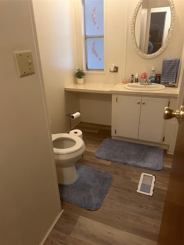 480 NE 64th Ave, Ocala, FL 34470 - half bathroom featuring wood finished floors, vanity, and toilet