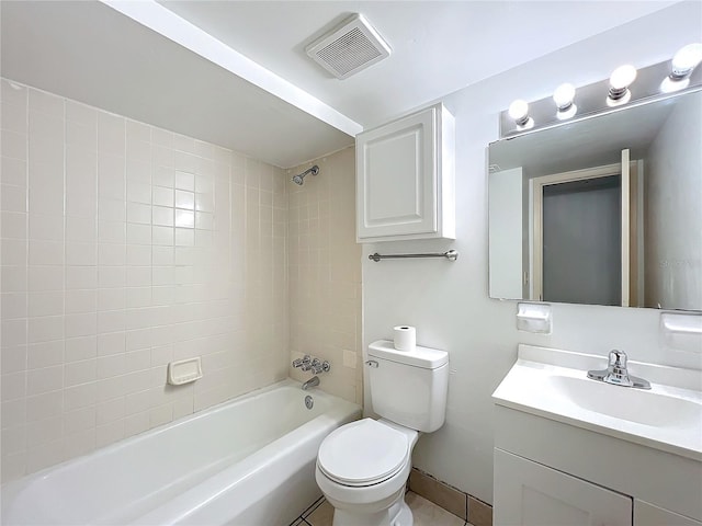 full bathroom featuring toilet, tile patterned floors, tiled shower / bath, and vanity