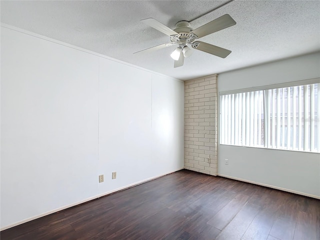 spare room with ceiling fan, dark hardwood / wood-style floors, and a textured ceiling