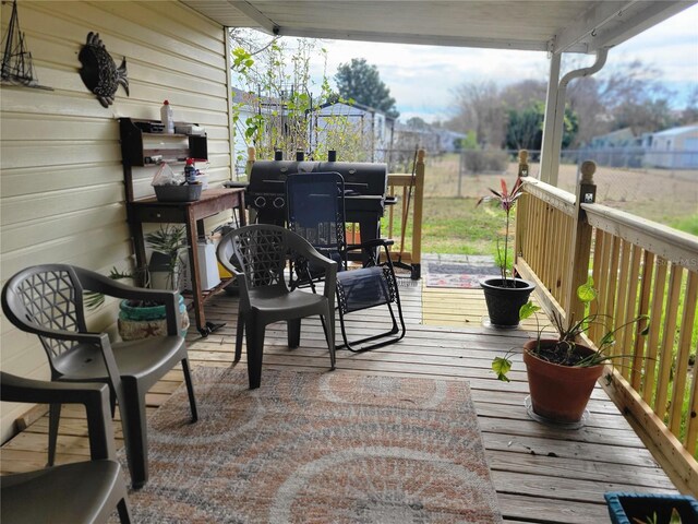 wooden terrace featuring grilling area