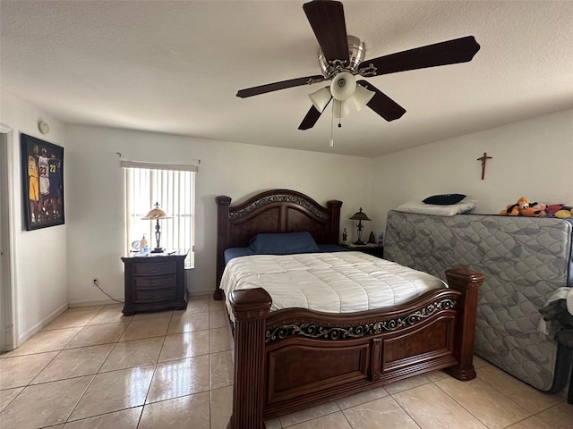 tiled bedroom featuring ceiling fan