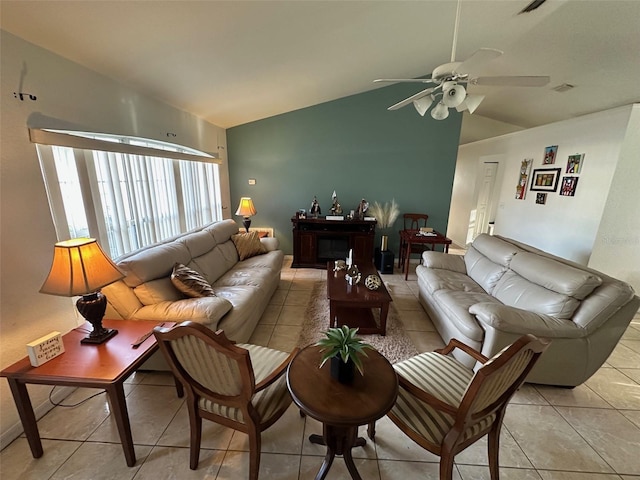 living room with vaulted ceiling, ceiling fan, and light tile patterned floors