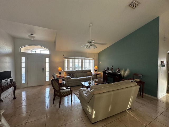 tiled living room featuring ceiling fan and high vaulted ceiling