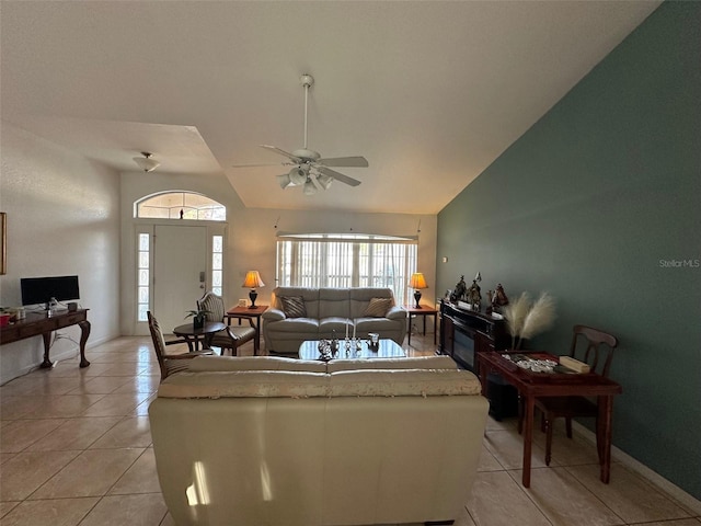 living room featuring ceiling fan, vaulted ceiling, and light tile patterned flooring