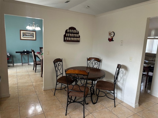 tiled dining space featuring ornamental molding and a chandelier