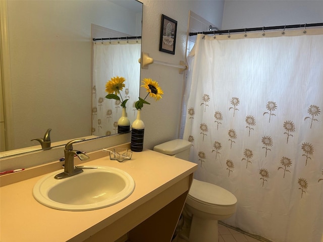 bathroom with tile patterned floors, toilet, and vanity