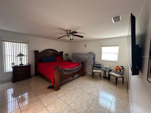 tiled bedroom featuring ceiling fan