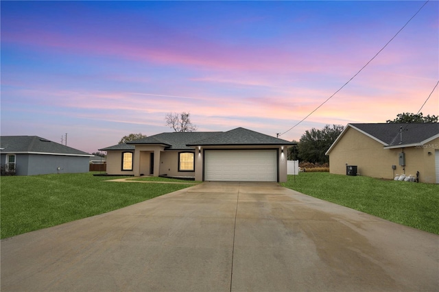 view of front of home featuring a garage and a yard