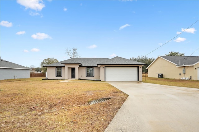 single story home with a garage and a front yard