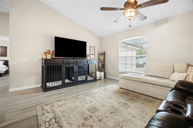 living room with lofted ceiling, ceiling fan, and light hardwood / wood-style floors