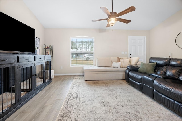 living room with ceiling fan and light hardwood / wood-style flooring