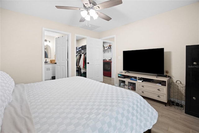 bedroom with ceiling fan, a closet, a spacious closet, and connected bathroom