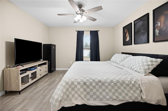 bedroom with ceiling fan and light hardwood / wood-style floors