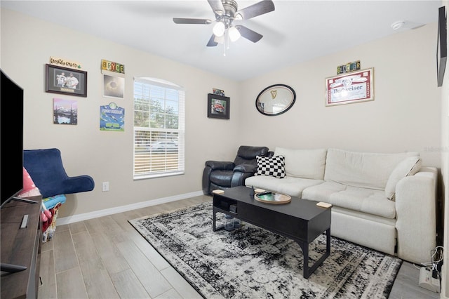 living room featuring ceiling fan and light hardwood / wood-style flooring